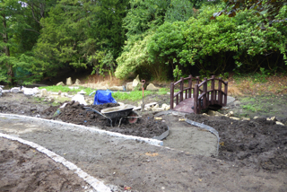 Johnny Clasper's stream replacement to the drain from the skate board park. Liz discussing the watercourse with the contractors,and Jonny working to improve the weir.